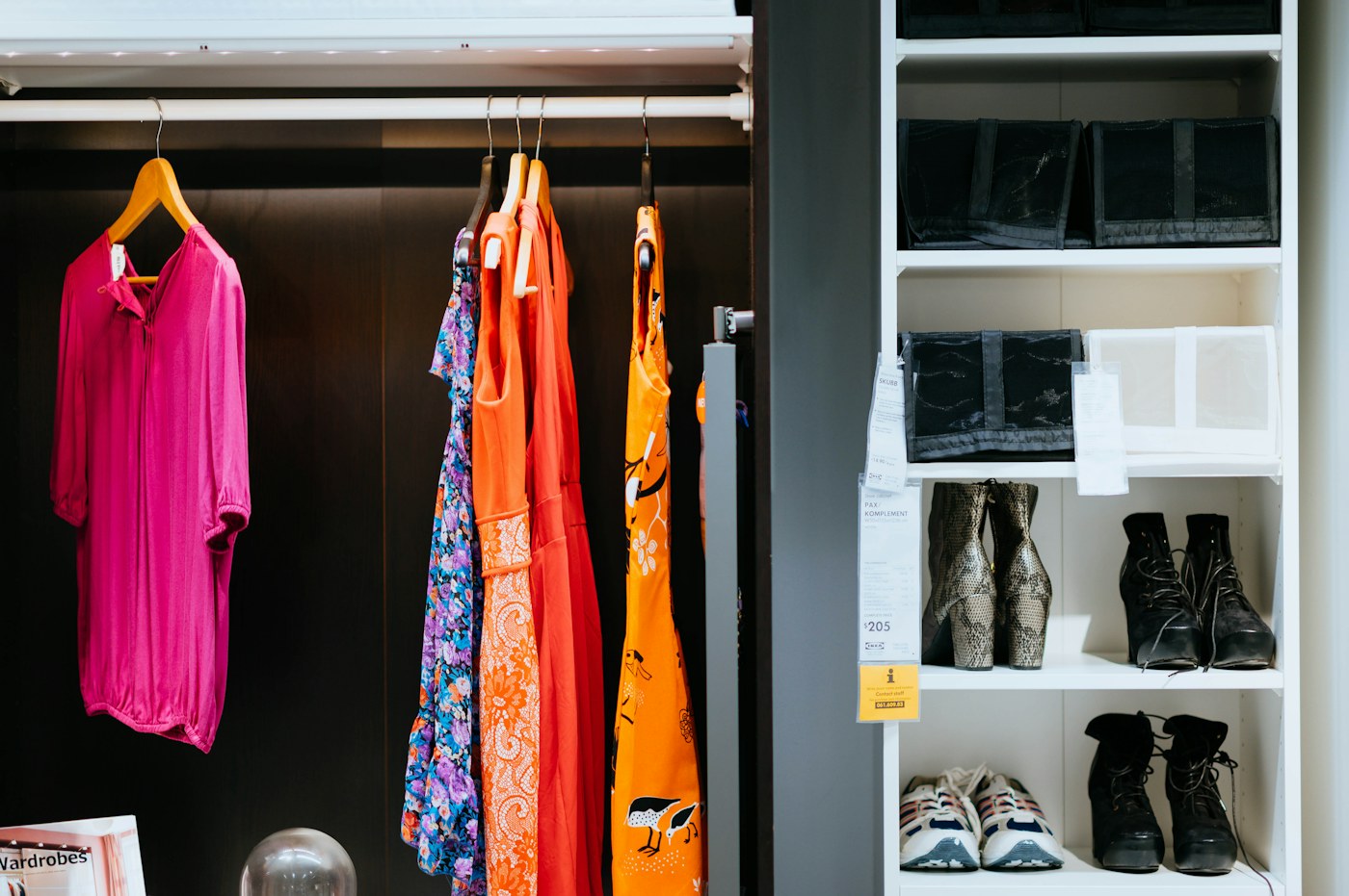 Clothes and shoes arranged inside a wardrobe