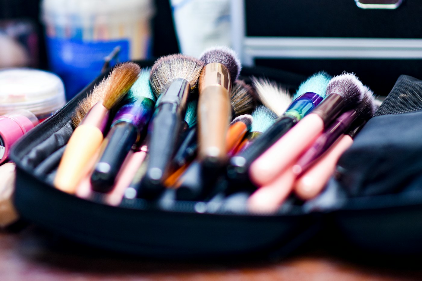 Makeup brushes and cosmetics in an open makeup bag